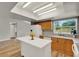 Bright kitchen with wood cabinets, white island and flooring at 840 Baybreeze Ln, Altamonte Springs, FL 32714