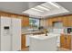 Bright kitchen featuring wood cabinets, ample counter space, a center island, and modern appliances at 840 Baybreeze Ln, Altamonte Springs, FL 32714