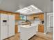 Well-lit kitchen featuring wood cabinets, a skylight, modern appliances, and a center island at 840 Baybreeze Ln, Altamonte Springs, FL 32714