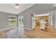 Bright living room featuring a ceiling fan, wood floors, and access to the kitchen and outdoor patio at 840 Baybreeze Ln, Altamonte Springs, FL 32714