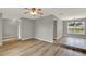 Spacious living area with wood-look floors, ceiling fan, and easy access to adjoining rooms; neutral gray walls at 840 Baybreeze Ln, Altamonte Springs, FL 32714