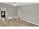 Bright living room with wood-look flooring and ceiling fan; neutral paint offers a clean, modern appeal at 840 Baybreeze Ln, Altamonte Springs, FL 32714