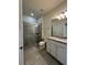Beautiful bathroom with granite countertops on the vanity, tile flooring, and shower with glass door at 8930 Zurich Ln, Kissimmee, FL 34747