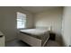 Cozy bedroom featuring a white frame bed, tile flooring, and natural light from the window at 8930 Zurich Ln, Kissimmee, FL 34747