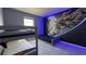 Themed bedroom featuring bunk beds, tile flooring, and spaceship mural on the wall at 8930 Zurich Ln, Kissimmee, FL 34747