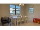 Bright dining room with a large window, a white dining table, and an elegant mirror at 8930 Zurich Ln, Kissimmee, FL 34747