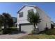 Charming two-story home featuring a well-manicured lawn and lush landscaping at 8930 Zurich Ln, Kissimmee, FL 34747