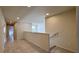 Bright hallway with neutral tones, tile flooring and view of staircase and landing area at 8930 Zurich Ln, Kissimmee, FL 34747