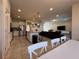 Open-concept kitchen and living room with stainless steel appliances, ample counter space, and comfortable seating at 8930 Zurich Ln, Kissimmee, FL 34747