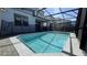 Backyard swimming pool with screened in lanai and brick pavers at 8930 Zurich Ln, Kissimmee, FL 34747