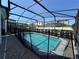 Backyard swimming pool with screened in lanai and brick pavers at 8930 Zurich Ln, Kissimmee, FL 34747