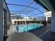 Backyard pool with dark mesh enclosure and pavers at 8930 Zurich Ln, Kissimmee, FL 34747