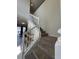 Elegant staircase with carpeted steps and white railings, connecting to a bright living space at 8930 Zurich Ln, Kissimmee, FL 34747