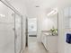 Primary bathroom showcases tiled shower, vanity and tile flooring at 9425 Holliston Creek Pl, Winter Garden, FL 34787