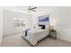 Bright bedroom features a ceiling fan, neutral walls, and a plush queen bed at 9425 Holliston Creek Pl, Winter Garden, FL 34787