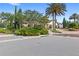 Elegant community clubhouse with mature landscaping, palm trees, and a brick-paved driveway at 9425 Holliston Creek Pl, Winter Garden, FL 34787