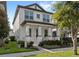 Two-story home with a well-kept lawn and a welcoming front porch with columns and landscaped garden at 9425 Holliston Creek Pl, Winter Garden, FL 34787