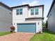 Two-story home featuring a teal garage door, brick driveway, and neat landscaping at 9425 Holliston Creek Pl, Winter Garden, FL 34787