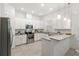 Bright kitchen features stainless steel appliances, granite countertops, and white cabinetry at 9425 Holliston Creek Pl, Winter Garden, FL 34787