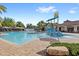 Resort-style pool with water slide, sun loungers, and meticulously maintained landscaping at 9425 Holliston Creek Pl, Winter Garden, FL 34787