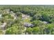 A high aerial view of the home surrounded by trees and other houses at 9616 River Walk Ct, Orlando, FL 32825