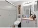 Well-lit bathroom with a glass-enclosed shower, a vanity with storage, and a large mirror at 9616 River Walk Ct, Orlando, FL 32825