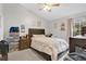Cozy bedroom with a comfortable bed, neutral decor, and ample natural light from the window at 9616 River Walk Ct, Orlando, FL 32825