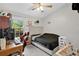 Cozy bedroom features a ceiling fan, white walls and a window for natural light at 9616 River Walk Ct, Orlando, FL 32825
