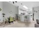 Bright dining area with modern table, chairs, and bar seating, complemented by a skylight and open kitchen at 9616 River Walk Ct, Orlando, FL 32825