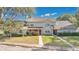Charming two-story townhome with a well-maintained lawn and sidewalk leading to a welcoming front entrance at 9616 River Walk Ct, Orlando, FL 32825