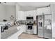 Modern kitchen with stainless steel appliances, granite countertops, and sleek white cabinets at 9616 River Walk Ct, Orlando, FL 32825