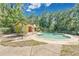Relaxing pool area with lush greenery, a pool house and a table at 9616 River Walk Ct, Orlando, FL 32825