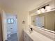 Modern bathroom featuring a new vanity, sleek fixtures, and a large, well lit mirror at 965 Brentwood Dr, Apopka, FL 32712