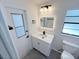 Updated bathroom featuring a modern vanity, lighted mirror, and a door leading to the outside at 965 Brentwood Dr, Apopka, FL 32712
