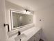 Well-lit bathroom with a modern vanity, large mirror, and sleek fixtures at 965 Brentwood Dr, Apopka, FL 32712