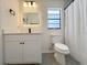 Cozy bathroom with a new vanity, modern mirror, and a shower with tiled walls at 965 Brentwood Dr, Apopka, FL 32712