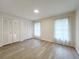Well-lit bedroom offering wood-look floors, white walls, and multiple closets for ample storage at 965 Brentwood Dr, Apopka, FL 32712