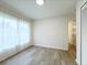 Bright bedroom with wood-look floors, sheer curtains, and a closet, creating a serene space at 965 Brentwood Dr, Apopka, FL 32712