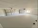 Spacious garage with freshly painted floor, a garage door, and a window offering natural light at 965 Brentwood Dr, Apopka, FL 32712