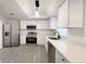 Beautiful kitchen with white cabinetry, stainless steel appliances, and modern pendant lighting at 965 Brentwood Dr, Apopka, FL 32712