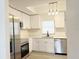 Stylish kitchen featuring white cabinets, stainless steel appliances, and modern light fixtures at 965 Brentwood Dr, Apopka, FL 32712
