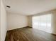 Inviting living room showcasing wood-look floors and a sliding glass door with view of the pool at 965 Brentwood Dr, Apopka, FL 32712