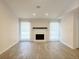 Spacious living room with a white-painted brick fireplace, wood-look floors, and bright natural light at 965 Brentwood Dr, Apopka, FL 32712