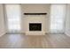 Bright living room featuring a painted brick fireplace and large windows with sheer white curtains at 965 Brentwood Dr, Apopka, FL 32712