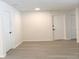Spacious living room featuring light wood-look floors and white walls connecting to other rooms at 965 Brentwood Dr, Apopka, FL 32712
