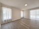 Bright and airy living room featuring modern flooring and large windows with sheer curtains at 965 Brentwood Dr, Apopka, FL 32712