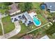 Aerial view of a home with solar panels, a pool, a fire pit, and a spacious backyard at 969 Gran Paseo Dr, Orlando, FL 32825