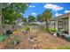 Landscaped backyard featuring a garden, patio area, and screened-in porch for outdoor enjoyment at 969 Gran Paseo Dr, Orlando, FL 32825