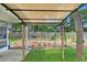 View of a well-maintained backyard garden area with a shade structure and lush greenery at 969 Gran Paseo Dr, Orlando, FL 32825