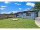 Spacious backyard with a stone fire pit and a neatly stacked woodpile, ideal for outdoor gatherings at 969 Gran Paseo Dr, Orlando, FL 32825